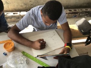 student focusing in painting during Fiji workshop